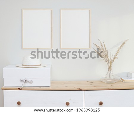 Two wooden frames mockup in light minimal boho interior, 2 blank frames hanging on wall in living room.	