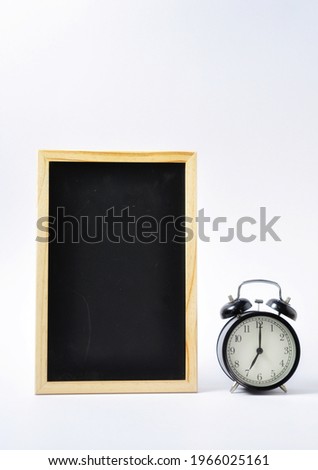 Blackboard and black alarm clock on white background minimalist style