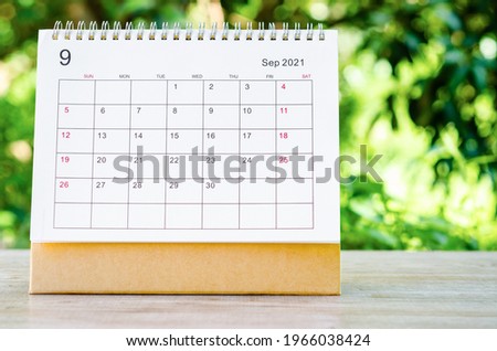 September 2021 Calendar desk for organizer to plan and reminder on wooden table on nature background. Royalty-Free Stock Photo #1966038424