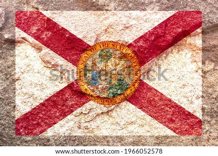 Vintage faded Florida state flag icon pattern isolated on weathered solid rock wall background, abstract positive design faithful USA Florida state politics society concept texture wallpaper