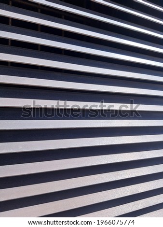 Background texture: striped protective street ventilation metal iron grates, stainless steel grating. Gray blinds, venting