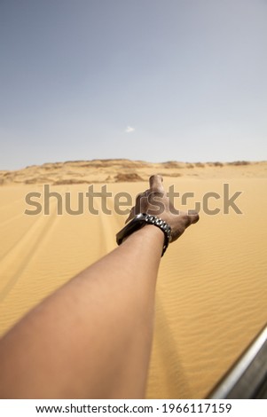 hand reaching out to the desert POV shot
 Royalty-Free Stock Photo #1966117159