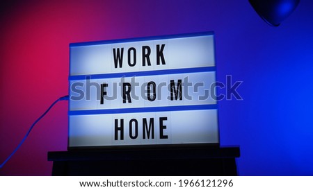 Work from home light box in studio. WFH Text on lightbox. Represent work from home for social distancing concept during coronavirus pandemic. WFH message on light board COVID 19 quarantine situation.