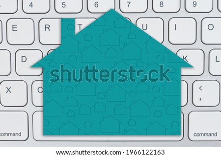 Blank teal house sign on gray keyboard for your online sales message