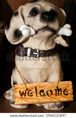 Animal Dog Toy holding Welcome Message Photo