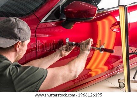 removal of dents without painting. PDR technology for car body repair Royalty-Free Stock Photo #1966126195