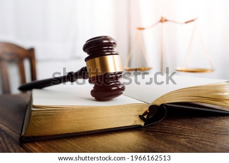 Business and lawyers discussing contract papers with brass scale on desk in office. Law, legal services, advice, justice and law concept picture with film grain effect