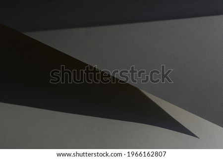 Shadow background. Grey paper texture. Abstract minimal composition.
