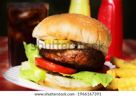 A great menu meal from a restaurant is the hamburger and fries with a cold drink as pictured here.