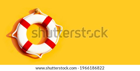 Lifebuoy on yellow background. Copy space Royalty-Free Stock Photo #1966186822