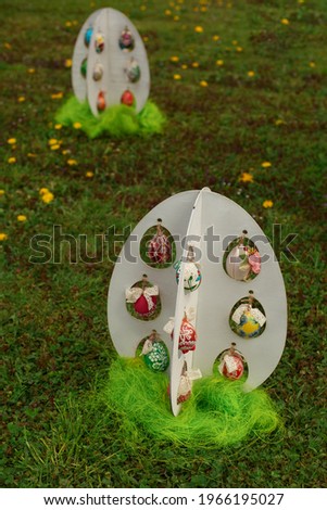 Decorated Easter Eggs In The Grass . Art Colorful Easter eggs decorated. Easter eggs in a nest. The minimal concept. Top view. Card with a copy of the place for the text.