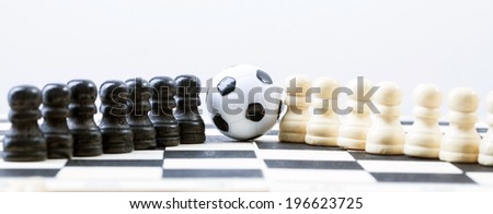 soccer ball of chess pieces on the board