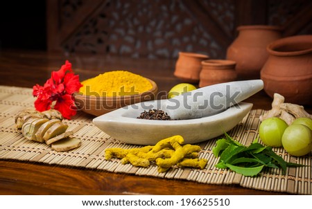 A selection of natural ingredients arranged in and around a marble mortar and pestle. Royalty-Free Stock Photo #196625510