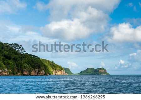 Scene seen from a boat trip on Iriomote coastline. Green mountains, blue sea and Sotobanari cape on background.  Royalty-Free Stock Photo #1966266295