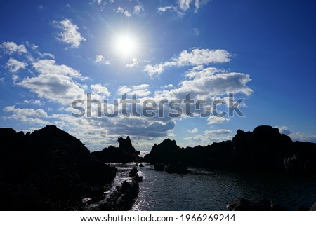 a wonderful rock beach with the sun, scenery around socheonji