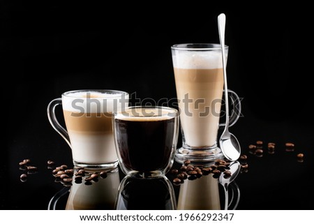 different types of coffee in glasses on a black mirror background, cappuccino, americano, latte macchiato, coffee beans Royalty-Free Stock Photo #1966292347