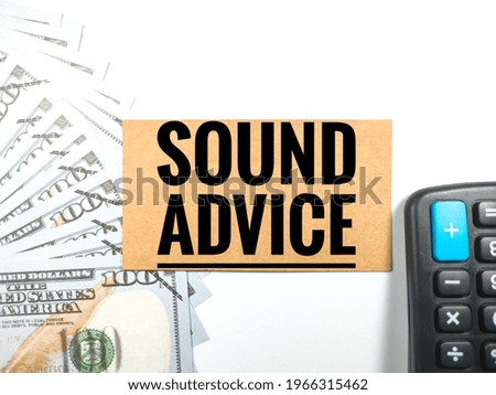 Business concept.Text SOUND ADVICE with calculator and banknote on white background.