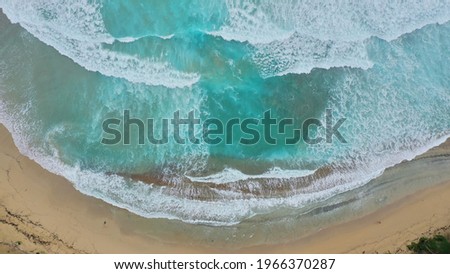 An aerial shot of a beach surrounded by the sea - great for wallpapers and backgrounds