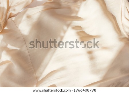 Abstract beige background flat layout. Modern minimalistic background with crumpled fabric texture and cotton folds. Top view for presentation