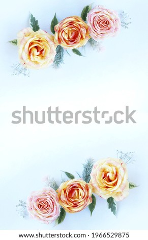 Pink and cream roses on a light blue background. A festive bouquet. Background for a greeting card.