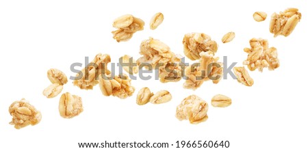 Falling oat granola, crunchy muesli isolated on white background Royalty-Free Stock Photo #1966560640