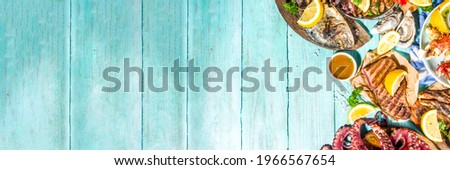 Assortment various barbecue Mediterranean grill food - fish, octopus, shrimp, crab, seafood, mussels, summer diet bbq party fest, with kebab, sauces, light blue sunne wooden background Royalty-Free Stock Photo #1966567654