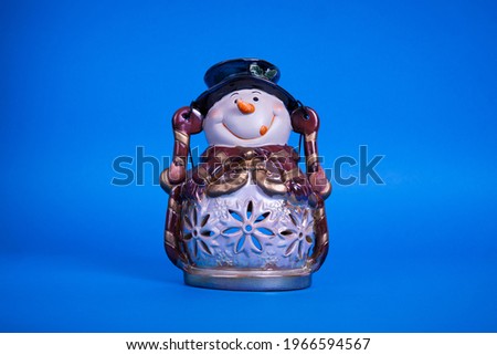 porcelain snowman on blue background