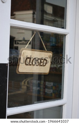 Closed sign in shop door window