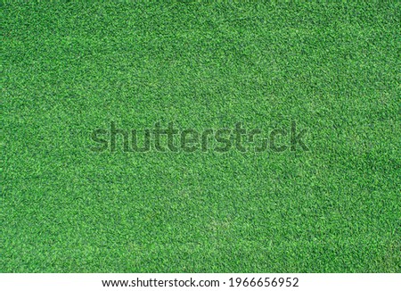 Green artificial grass texture background. Top view 