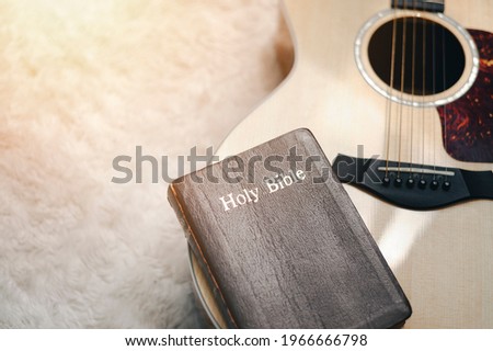 Christians worship God with a guitar with the Holy Bible. reading the Bible and sharing the gospel with copy space for the word of god. Royalty-Free Stock Photo #1966666798