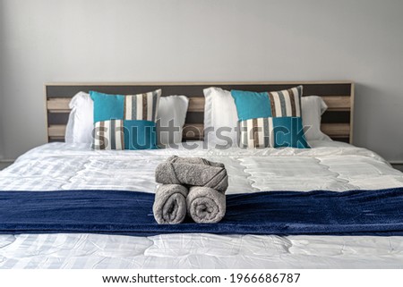 Closeup towel on queen size bed in the bedroom for service the customer, Studio room type of condominium or apartment, service apartment and Accommodations Concept Royalty-Free Stock Photo #1966686787