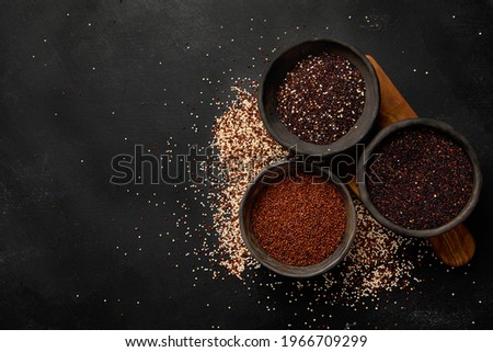 Set with different types of quinoa on dark background. Organic food concept. Top view, copy space