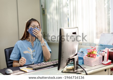 Female employee wears face mask in customer service for measures to prevent virus covid-19