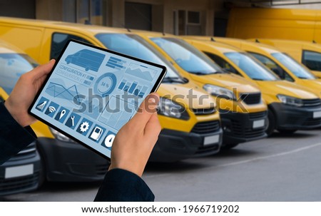Manager with a digital tablet on the background of vans. Fleet management Royalty-Free Stock Photo #1966719202