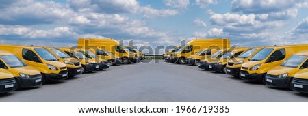 Yellow delivery vans parked in a rows Royalty-Free Stock Photo #1966719385