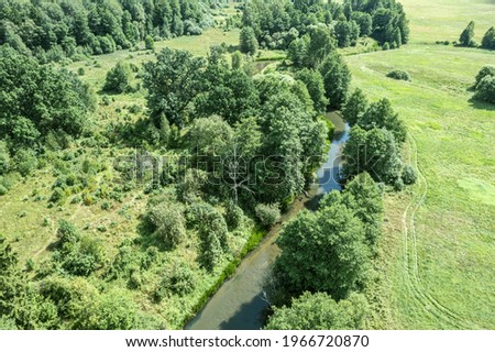winding river among field and forest. Isloch river valley, Belarus. aerial photo