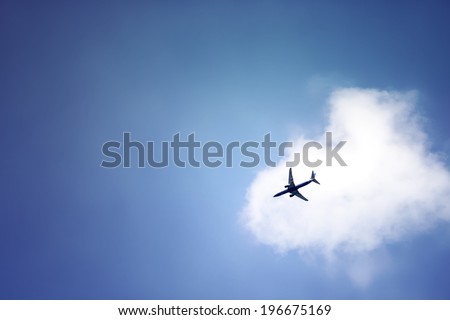 plane crossing a cloud vignette Royalty-Free Stock Photo #196675169