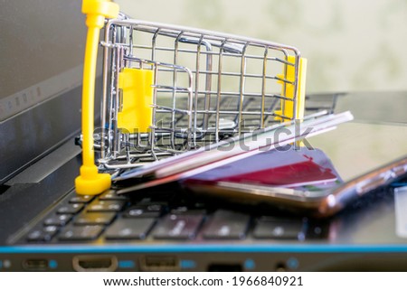 online shopping concept shopping cart on the laptop keyboard in the shopping cart smartphone and credit cards. High quality photo