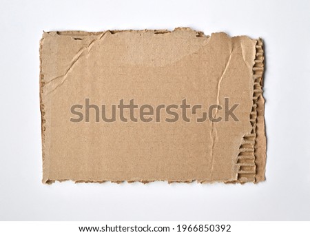 a piece of torn cardboard uneven edge white background Royalty-Free Stock Photo #1966850392