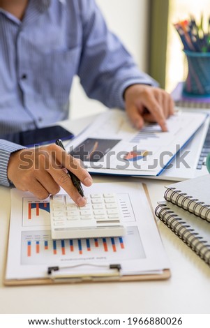 Businessman hands hold documents with financial statistic stock photo,discussion and report analysis data the charts and graphs. Finance concept