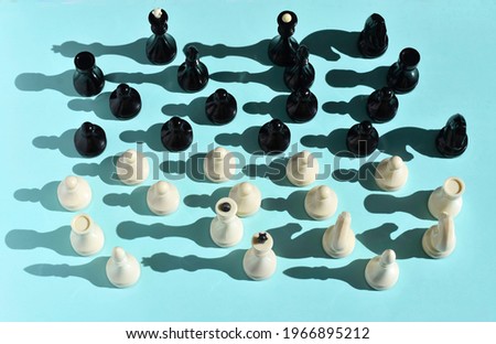 chess pieces arranged in a chaotic manner on a blue background