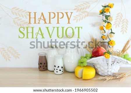 Photo of dairy products over wooden table. Symbols of jewish holiday - Shavuot