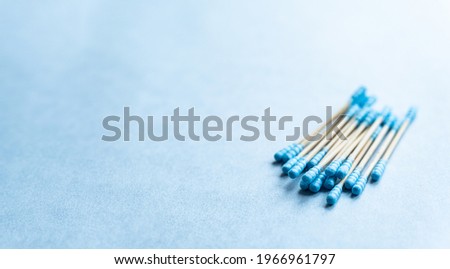 Eco friendly composition of bamboo cotton swabs on blue background, copy space. Sustainable lifestyle concept, zero waste, plastic free.