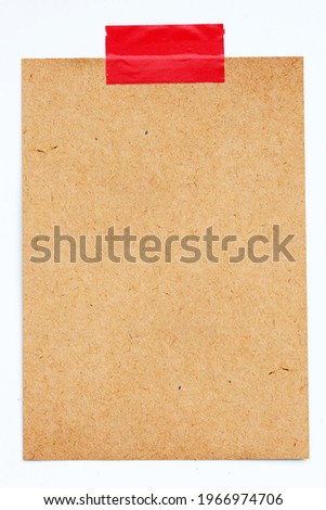 Brown paper with red electrical tape on white background.
