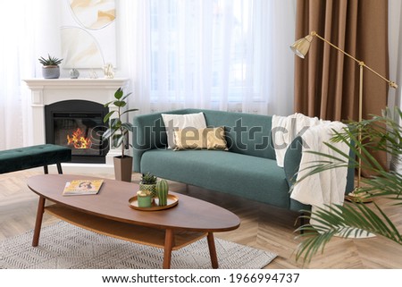 Stylish living room interior with comfortable sofa and wooden table