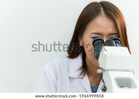 Woman technician Working analyzing microscope at laboratory