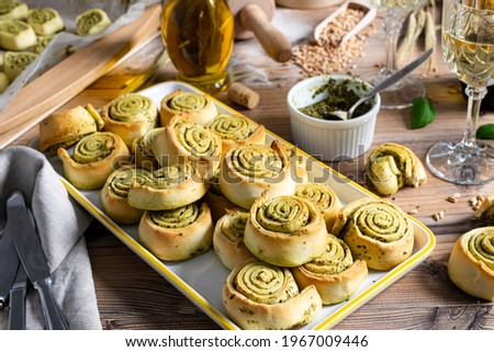 homemade pesto snails on wooden background