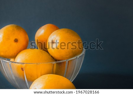 mangoes in basket blue dark background