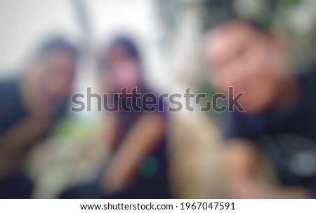 Two girls and one boy taking pictures and blurring