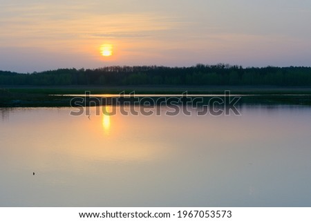 Scenery. Spring sunrise on the lake.